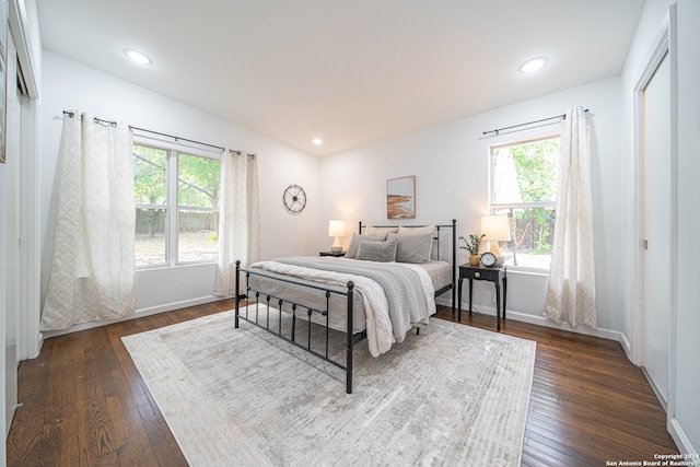 bedroom with dark wood-type flooring and vaulted ceiling