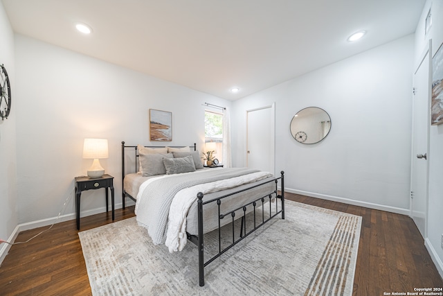 bedroom with dark wood-type flooring