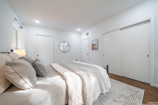 bedroom featuring dark hardwood / wood-style flooring and a closet