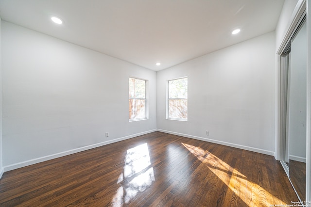 unfurnished bedroom with dark hardwood / wood-style flooring