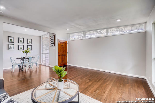 unfurnished living room featuring dark wood-type flooring and plenty of natural light