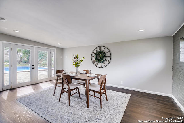 dining room featuring lofted ceiling, dark hardwood / wood-style floors, and french doors