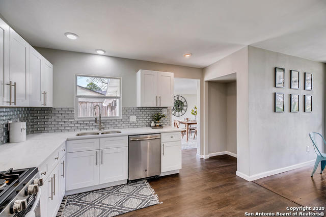 kitchen featuring white cabinetry, sink, tasteful backsplash, and stainless steel appliances