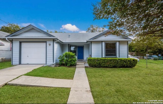 ranch-style house with a garage and a front lawn