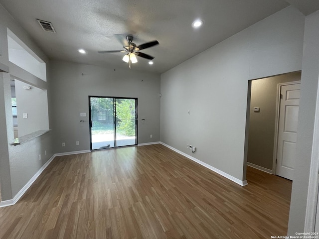 spare room featuring hardwood / wood-style flooring, a textured ceiling, and ceiling fan