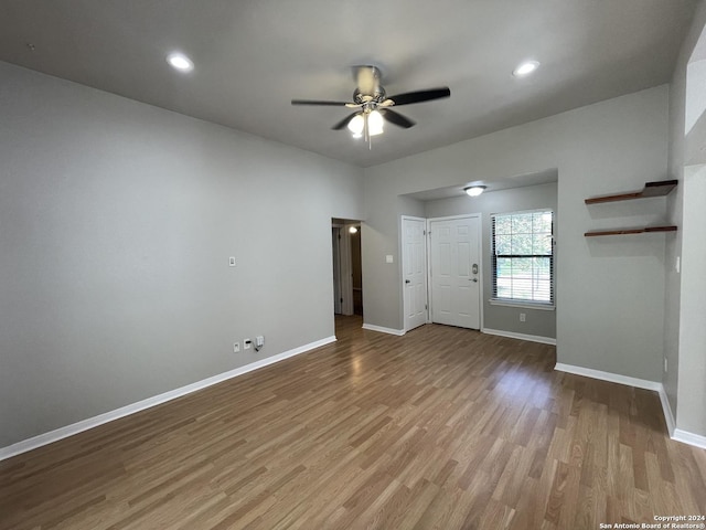 unfurnished living room featuring ceiling fan and light hardwood / wood-style flooring