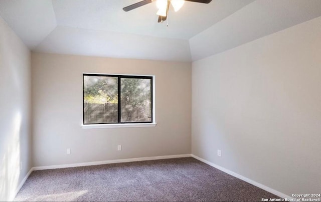 carpeted empty room with lofted ceiling and ceiling fan