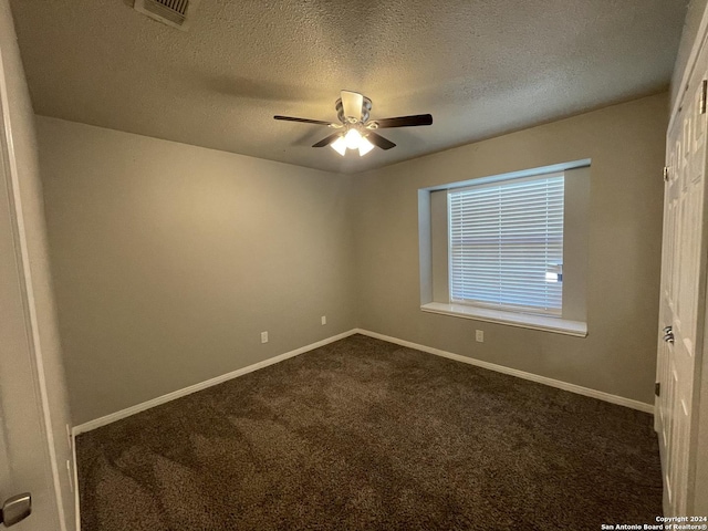 carpeted empty room with a textured ceiling and ceiling fan