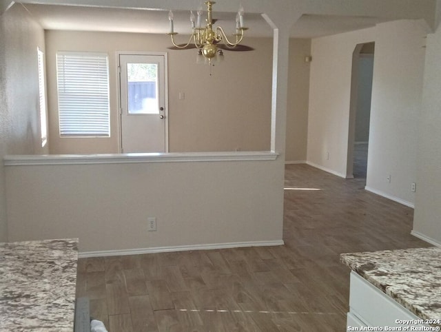 empty room featuring dark hardwood / wood-style floors and a notable chandelier