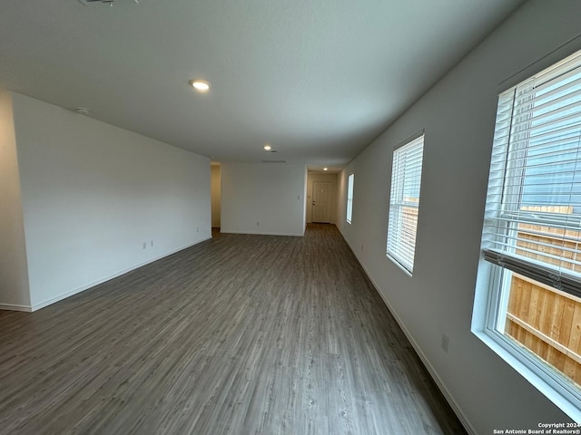 empty room with dark hardwood / wood-style flooring