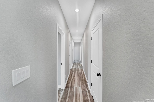 corridor featuring hardwood / wood-style floors