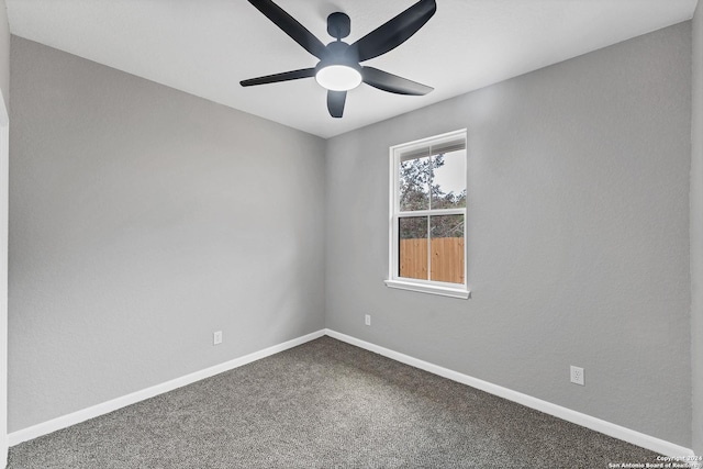 spare room featuring ceiling fan and carpet