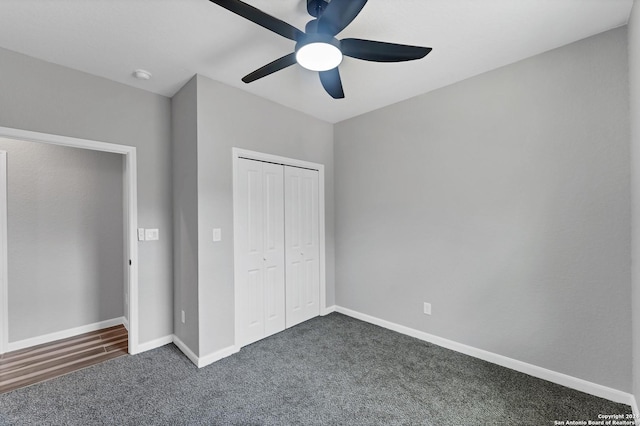 unfurnished bedroom featuring ceiling fan, dark carpet, and a closet