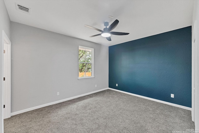 carpeted spare room featuring ceiling fan