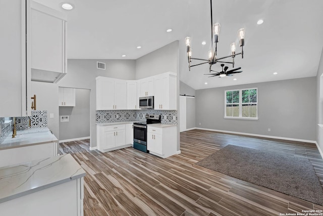 kitchen with decorative light fixtures, white cabinets, decorative backsplash, light stone counters, and stainless steel appliances