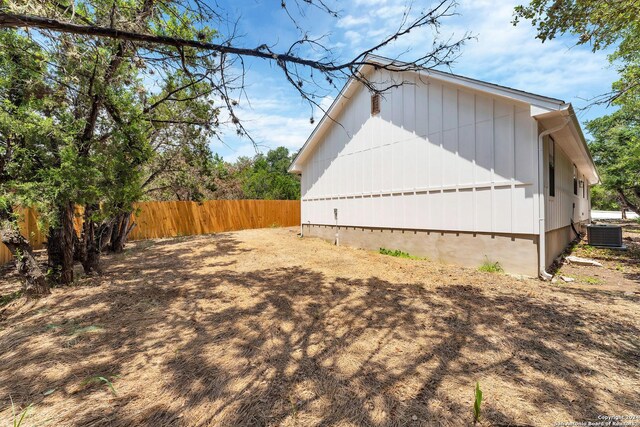 view of side of home featuring cooling unit