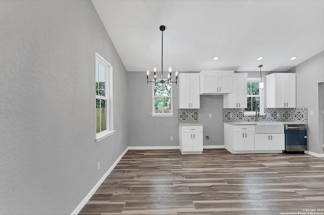 kitchen featuring white cabinetry, decorative light fixtures, dishwasher, and tasteful backsplash