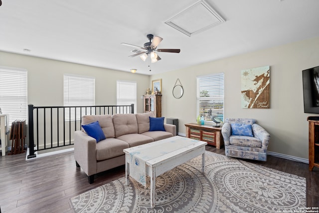 living room with ceiling fan, dark wood-type flooring, and plenty of natural light