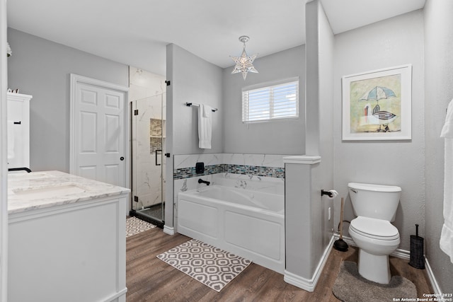 full bathroom with vanity, toilet, separate shower and tub, and hardwood / wood-style flooring