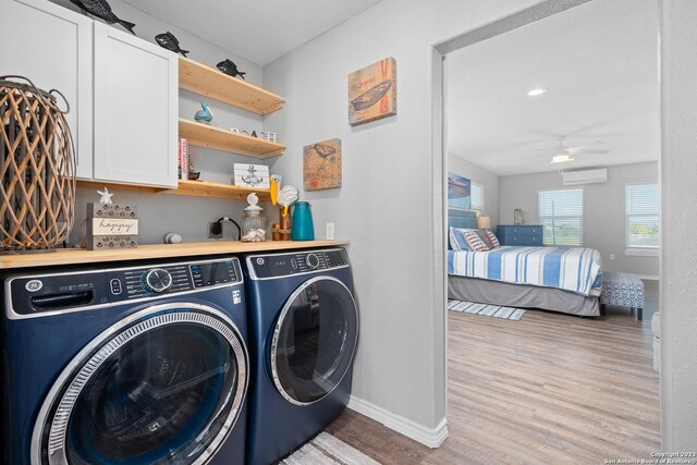 bathroom with dual vanity, hardwood / wood-style floors, and a bathtub