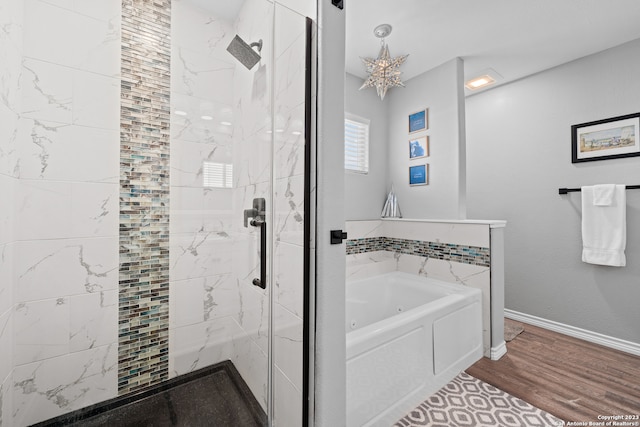 bathroom featuring plus walk in shower and hardwood / wood-style flooring