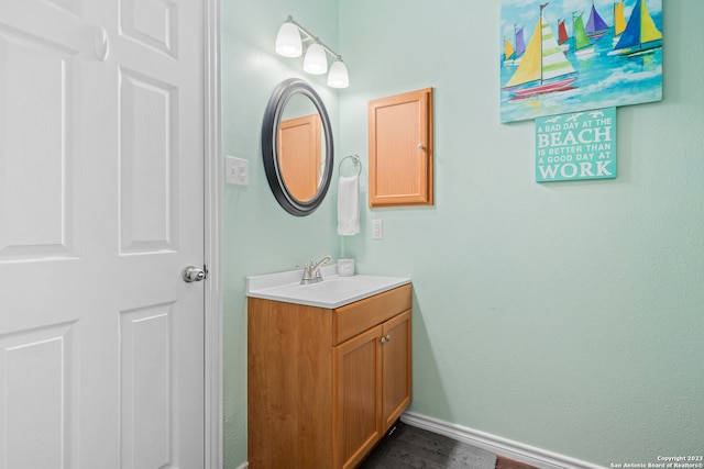 bathroom with vanity and wood-type flooring