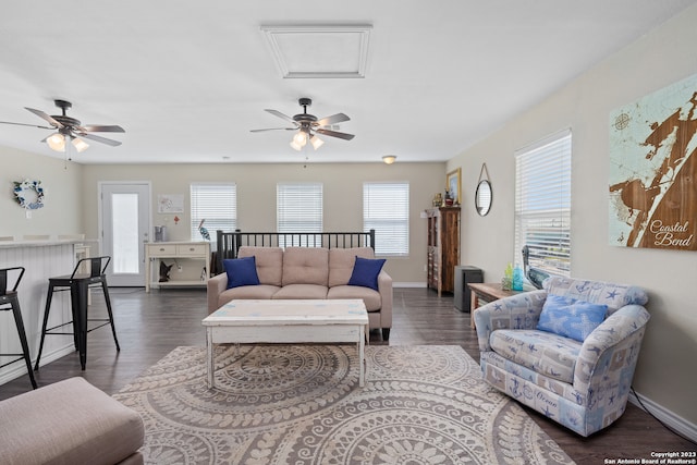 living room with dark wood-type flooring and ceiling fan