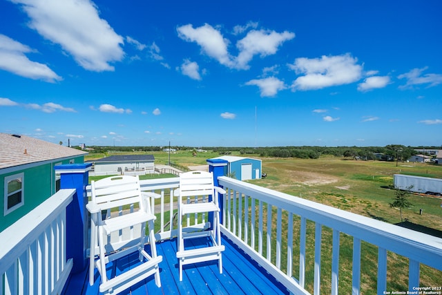 wooden deck featuring a lawn