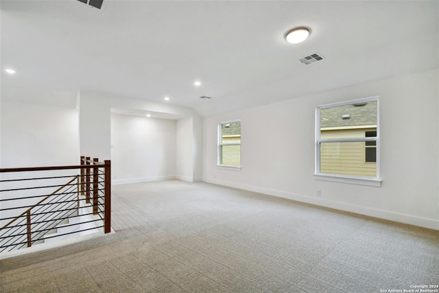 unfurnished room with light colored carpet