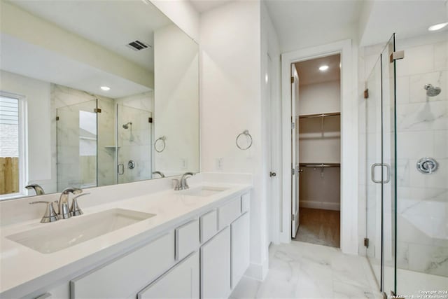 bathroom featuring vanity and a shower with door