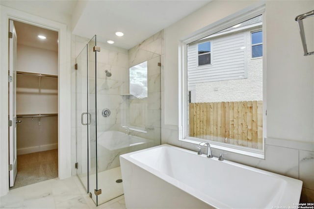 bathroom featuring independent shower and bath