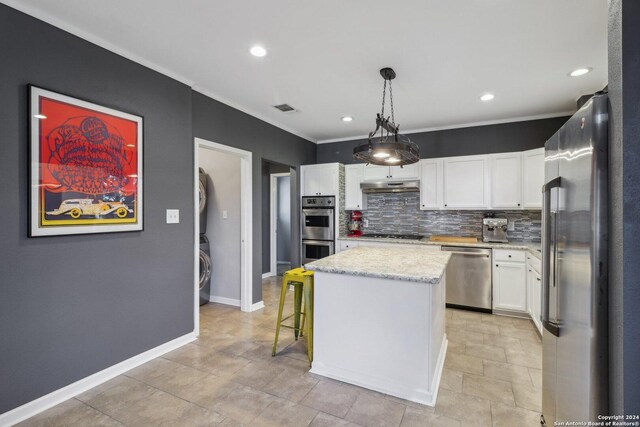 kitchen featuring decorative backsplash, light tile patterned flooring, appliances with stainless steel finishes, and white cabinets