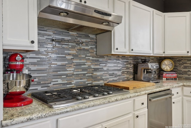 kitchen with white cabinets, backsplash, and stainless steel appliances