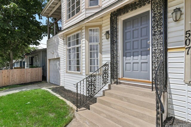 view of exterior entry with a garage