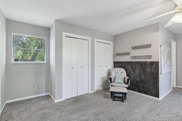 sitting room with carpet and ceiling fan