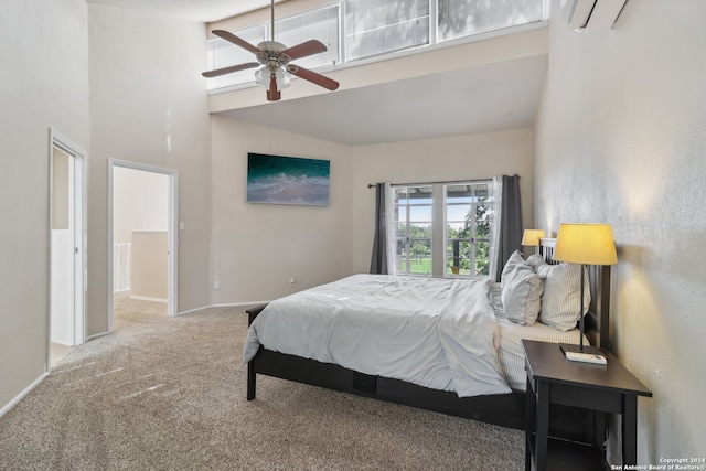 bedroom with carpet floors, a high ceiling, ceiling fan, and an AC wall unit