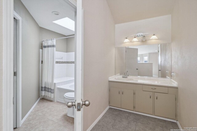 full bathroom featuring shower / bath combo with shower curtain, vanity, tile patterned flooring, and toilet