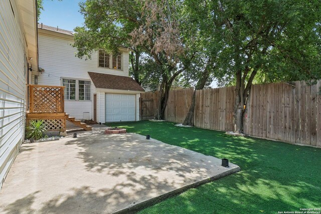 view of yard with a patio and a garage