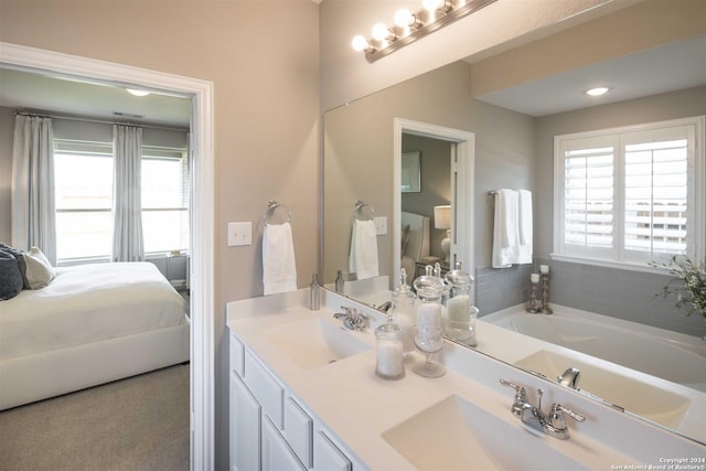 bathroom with vanity and a tub