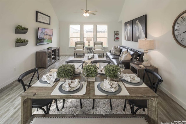 dining room with lofted ceiling, hardwood / wood-style floors, and ceiling fan