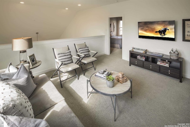 living room with carpet flooring and vaulted ceiling