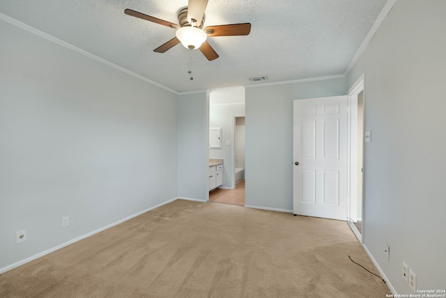 unfurnished bedroom featuring light carpet, connected bathroom, crown molding, and ceiling fan