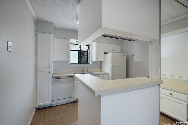 kitchen featuring tile patterned flooring, white appliances, a textured ceiling, white cabinets, and sink