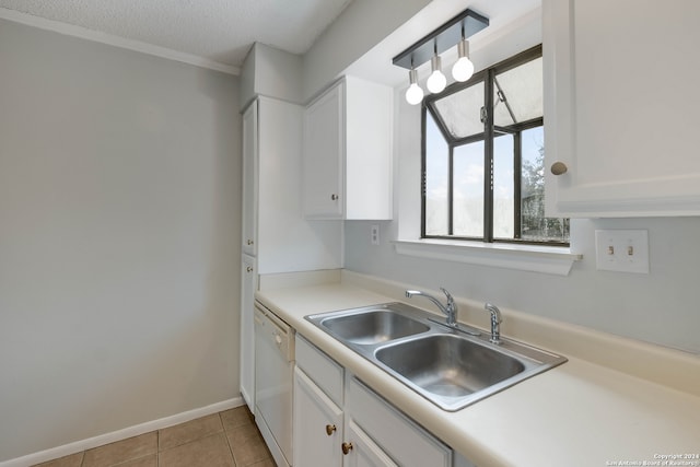 kitchen featuring light tile patterned floors, dishwasher, sink, and white cabinets