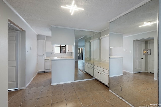 kitchen featuring light tile patterned flooring, white cabinetry, crown molding, dishwasher, and a textured ceiling