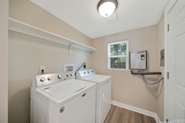 washroom featuring light hardwood / wood-style flooring and washer and clothes dryer