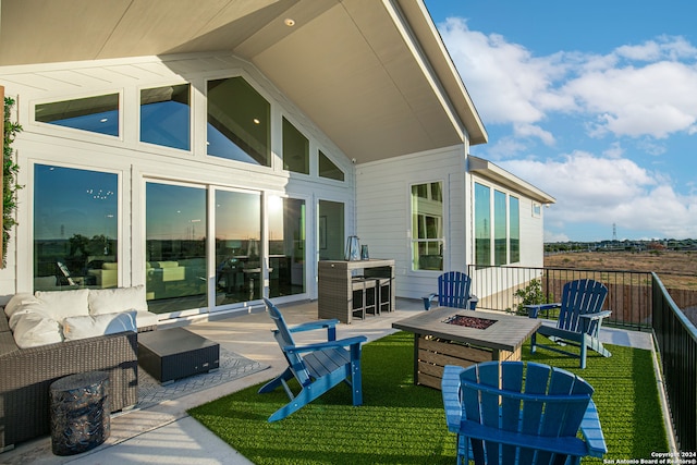 view of patio / terrace with an outdoor living space with a fire pit