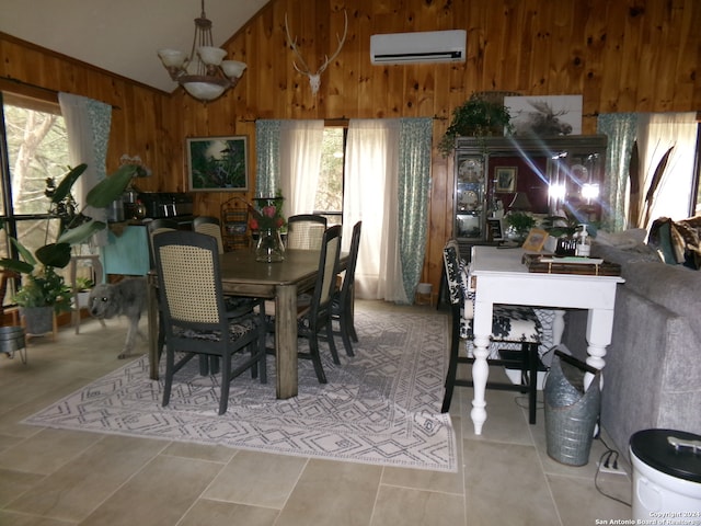 tiled dining area with a healthy amount of sunlight, a notable chandelier, a wall mounted air conditioner, and wooden walls