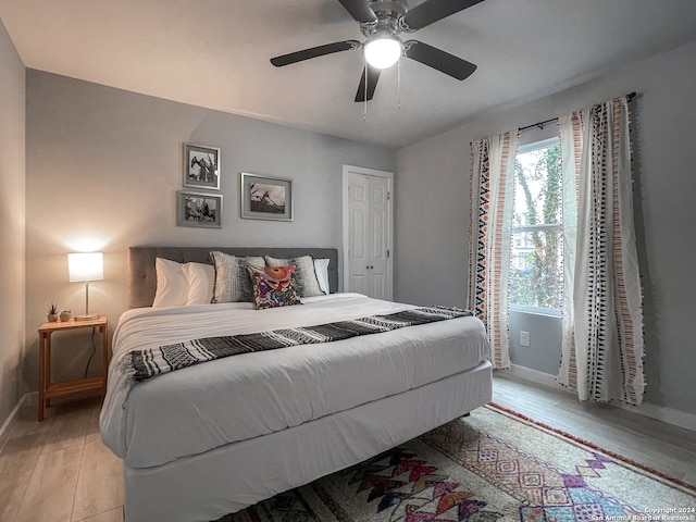 bedroom with ceiling fan and light hardwood / wood-style flooring