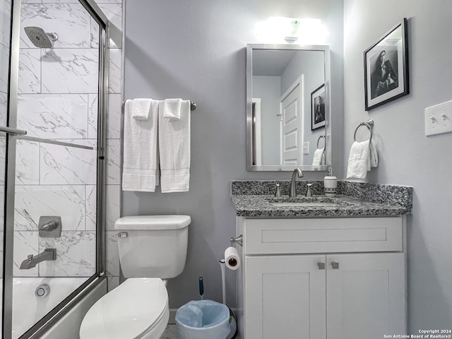 full bathroom with vanity, enclosed tub / shower combo, and toilet